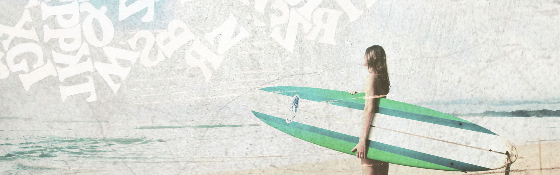 girl standing on a beach holding a surfboard